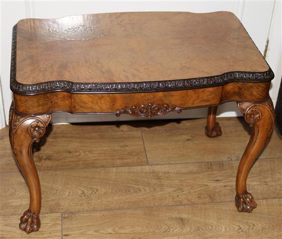 A burr walnut coffee table, with hairy paw feet W.69cm